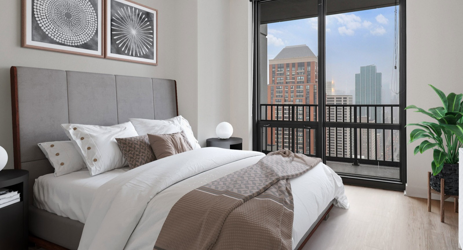 Inviting guest bedroom at SKY55 in Chicago, featuring a comfortable bed, stylish decor, and large windows with urban views