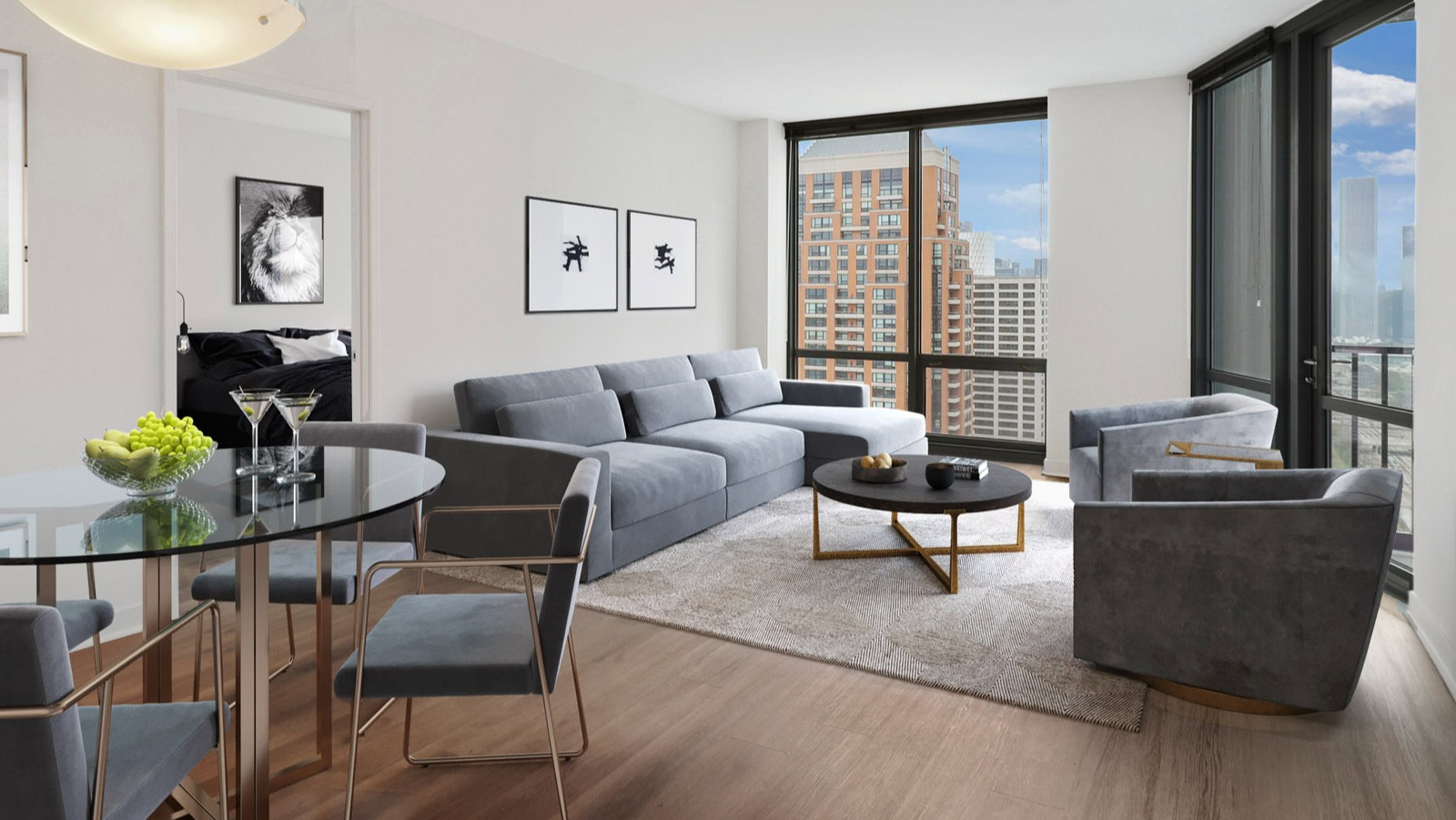 Elegant living and dining room at SKY55 in Chicago, featuring a comfortable gray sofa, glass dining table, and large windows with city views