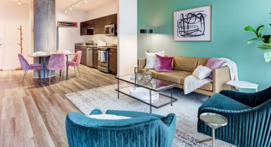 An open-concept living area and kitchen at SoNo East Apartments in Chicago, perfect for entertaining
