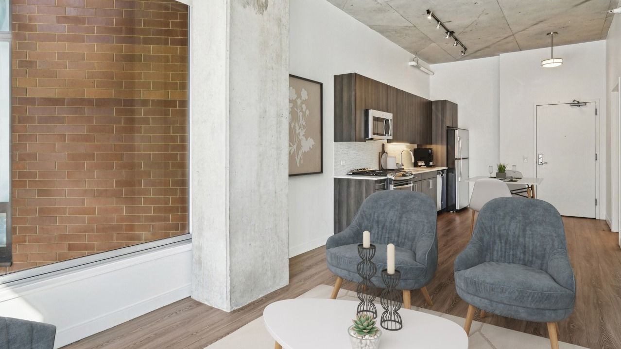 A cozy studio apartment kitchen and living area at Spoke in Chicago, with modern appliances and comfortable seating