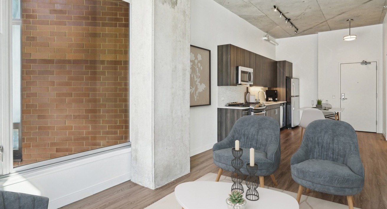 A cozy studio apartment kitchen and living area at Spoke in Chicago, with modern appliances and comfortable seating