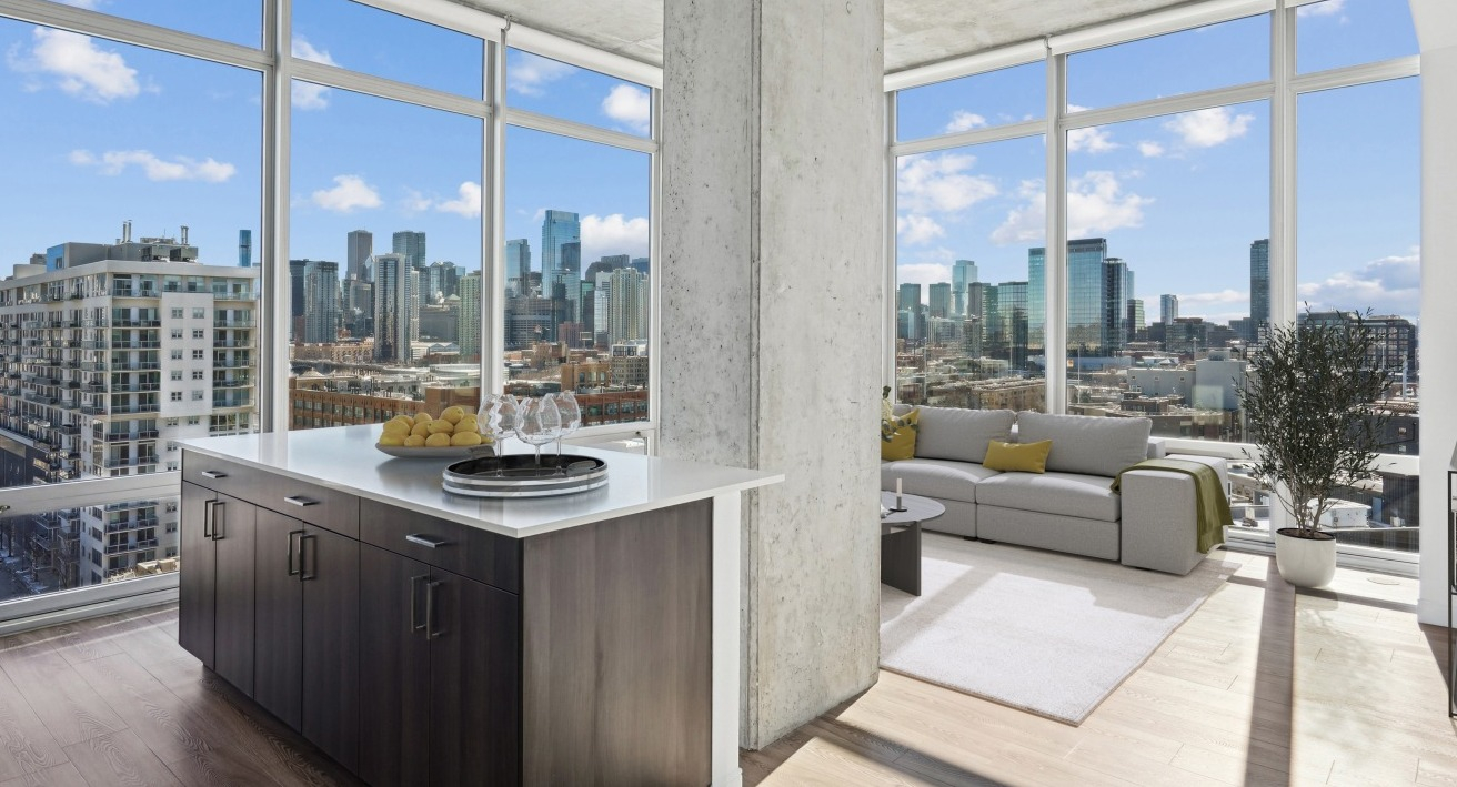 A luxury living space at Spoke Apartments in Chicago, featuring panoramic city views and a modern kitchen island