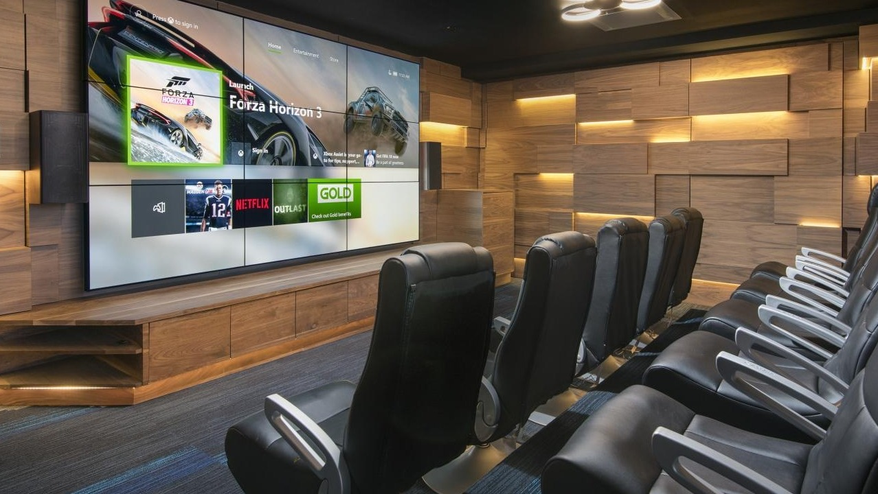 A luxurious private movie theater at Spoke Apartments in Chicago, with comfortable seating and a large screen