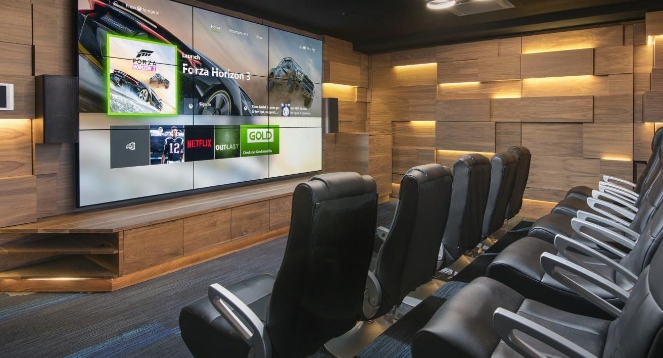 A luxurious private movie theater at Spoke Apartments in Chicago, with comfortable seating and a large screen