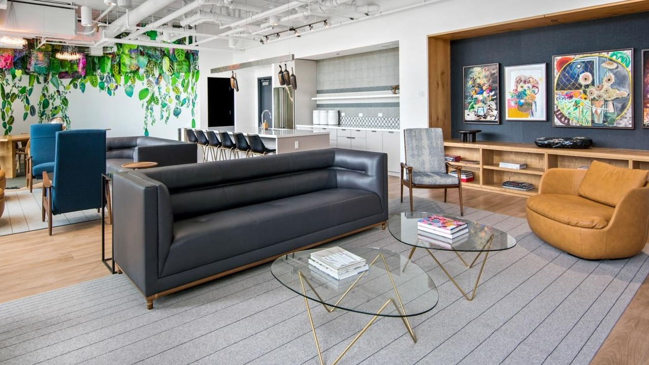 A vibrant resident lounge at Spoke Apartments in Chicago, featuring diverse seating areas and unique artwork