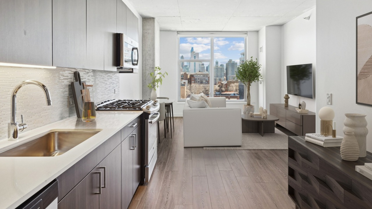 A sleek kitchen at Spoke Apartments in Chicago, featuring modern cabinetry, stainless steel appliances, and city views
