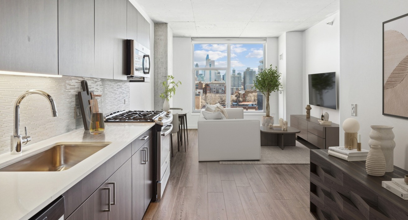 A sleek kitchen at Spoke Apartments in Chicago, featuring modern cabinetry, stainless steel appliances, and city views