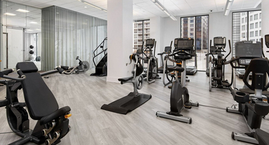 Bright cardio fitness center at State & Chestnut in Chicago, featuring a variety of exercise machines and ample space for workouts