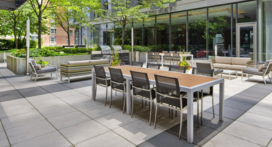 Spacious outdoor patio at State & Chestnut in Chicago, featuring dining tables, lounge seating, and convenient grilling stations