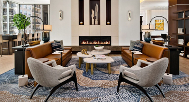 Luxurious resident lounge at State & Chestnut in Chicago, featuring leather sofas, accent chairs, and a contemporary fireplace
