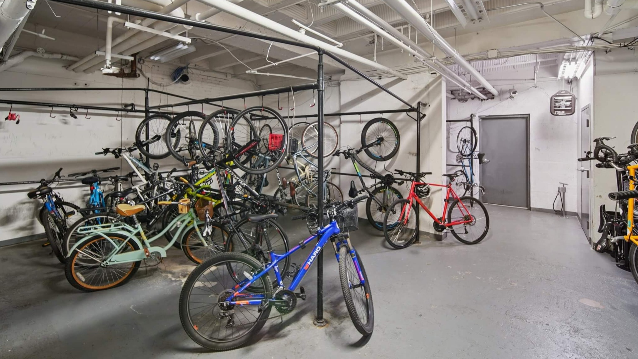 Spacious and organized bike storage room with multiple racks for resident bicycles at The Deco North Lake Shore apartments in Chicago