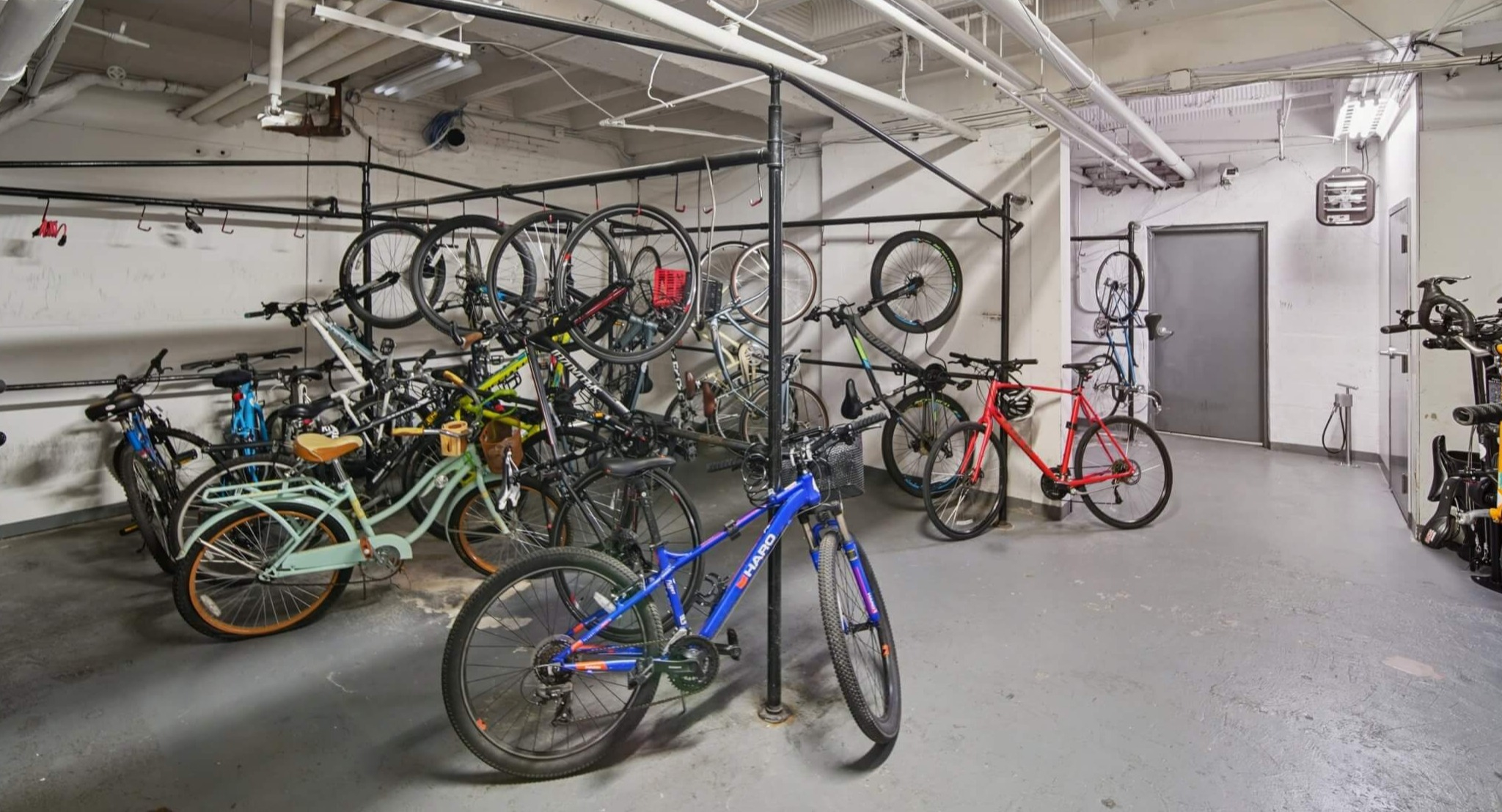 Spacious and organized bike storage room with multiple racks for resident bicycles at The Deco North Lake Shore apartments in Chicago
