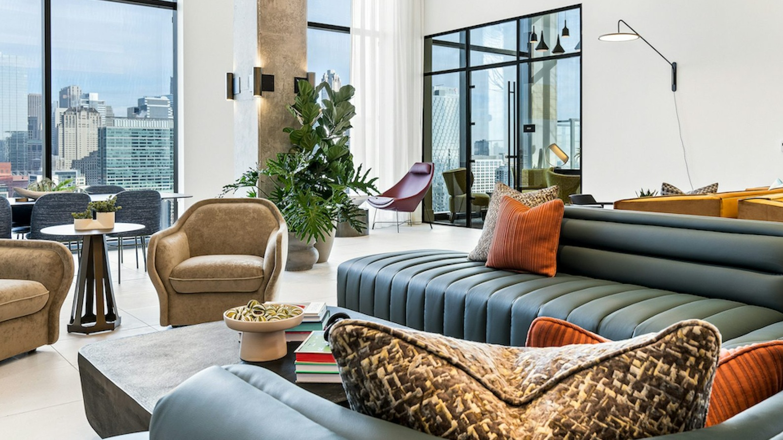 Stylish resident lounge seating area at The Dylan in Chicago with comfortable furniture and floor-to-ceiling windows
