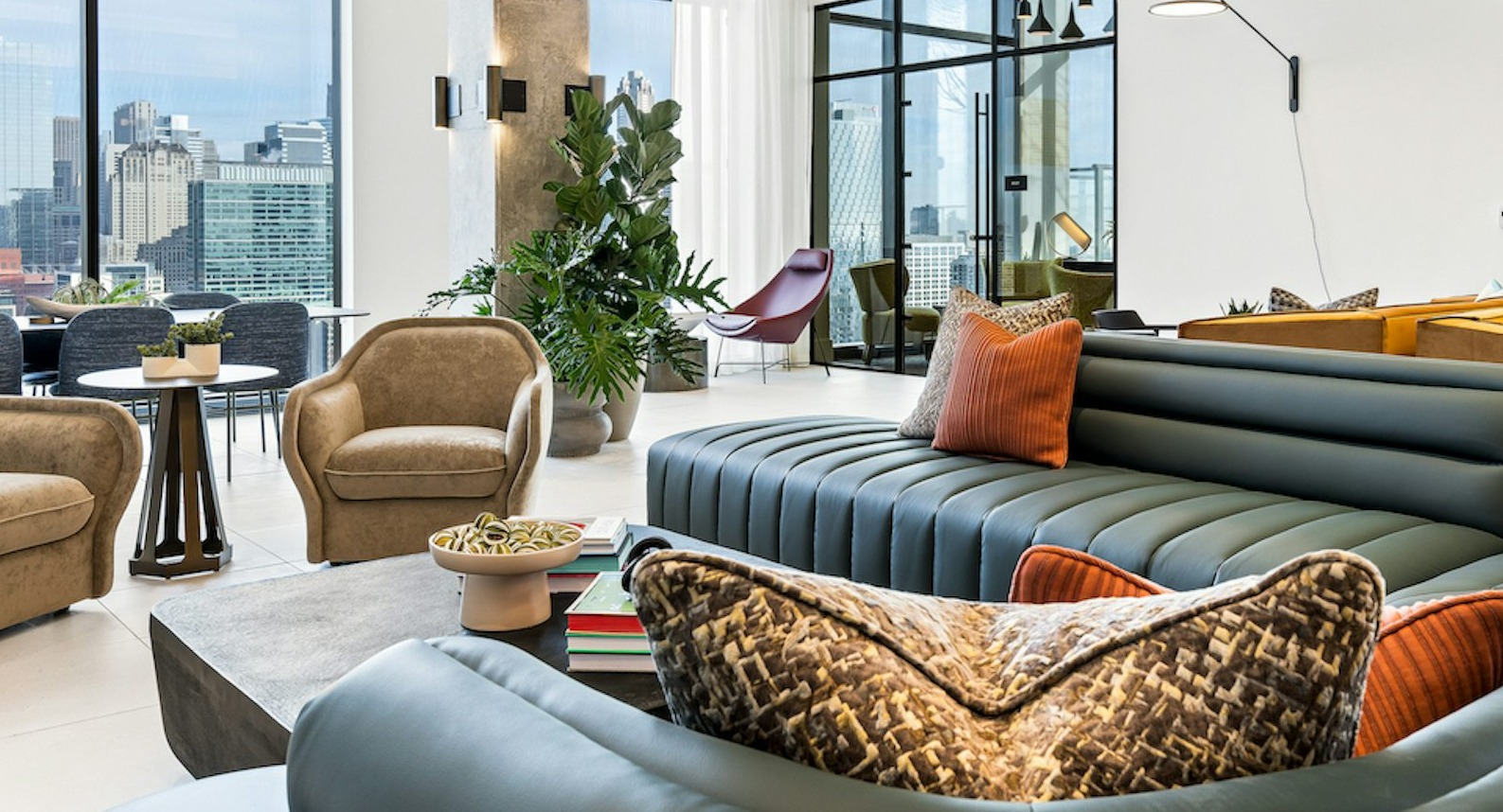 Stylish resident lounge seating area at The Dylan in Chicago with comfortable furniture and floor-to-ceiling windows