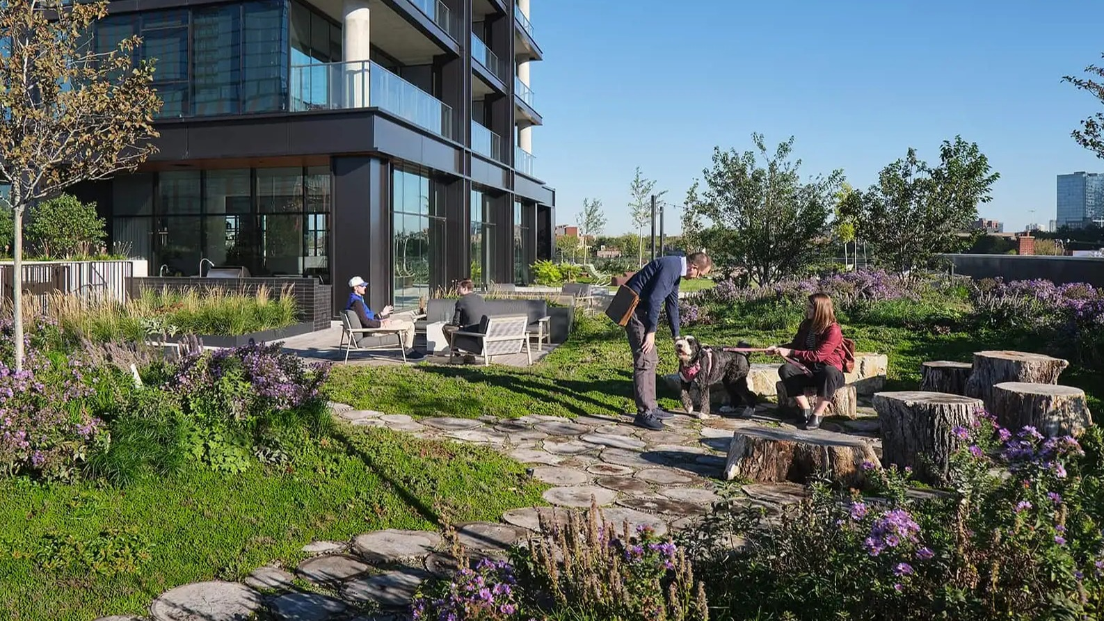Lush, pet-friendly courtyard at The Elizabeth Chicago, featuring walking paths, diverse greenery, and outdoor seating areas
