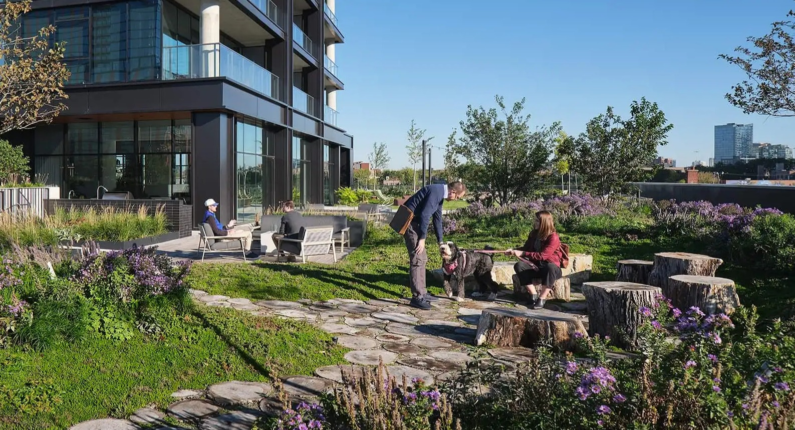 Lush, pet-friendly courtyard at The Elizabeth Chicago, featuring walking paths, diverse greenery, and outdoor seating areas