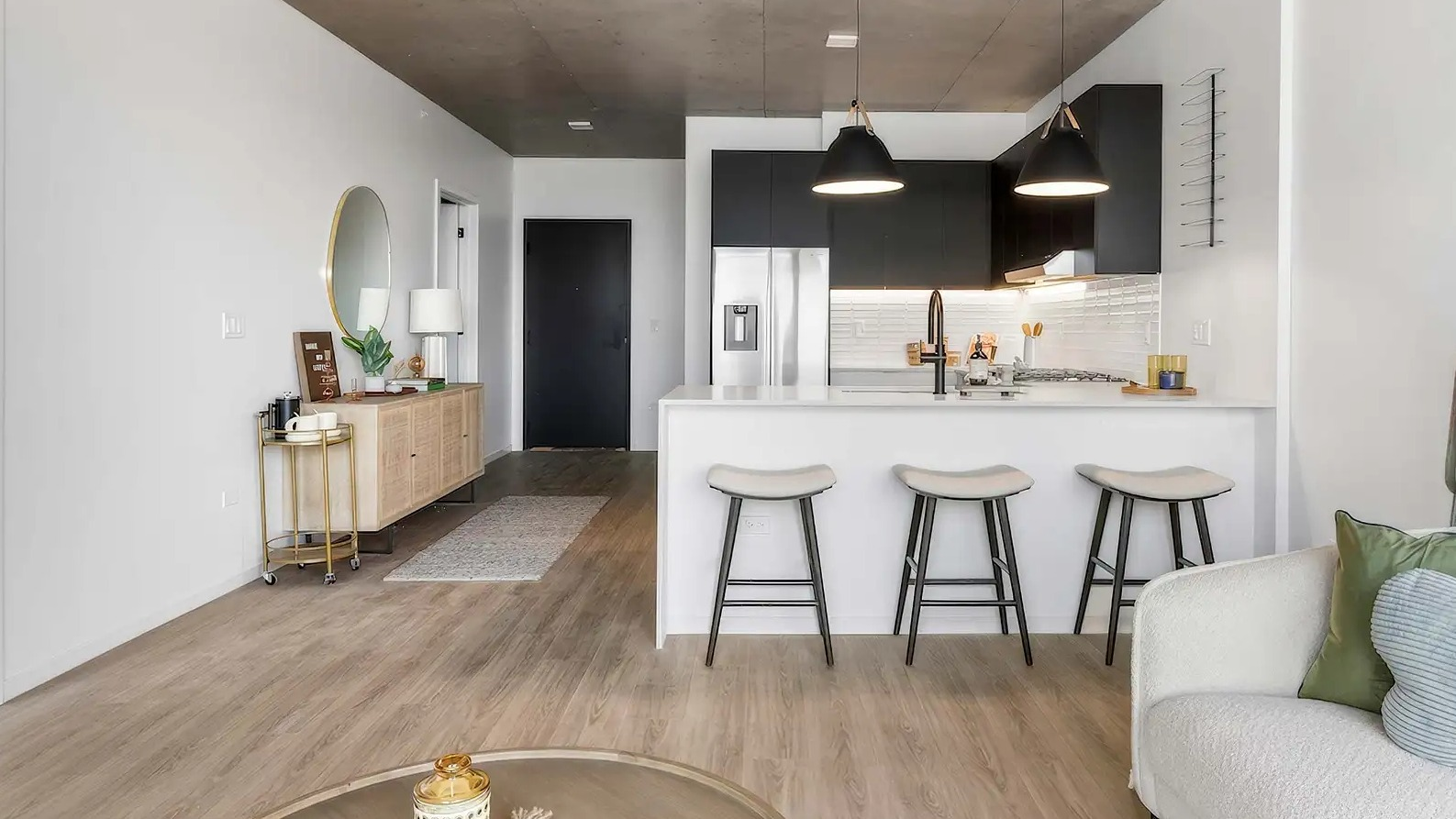 Welcoming apartment entryway leading into a spacious living room and modern kitchen at The Elizabeth Chicago