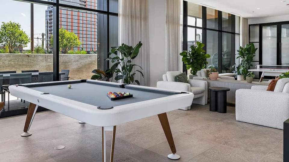 Stylish game room at The Elizabeth Chicago, featuring a modern billiards table and comfortable lounge seating