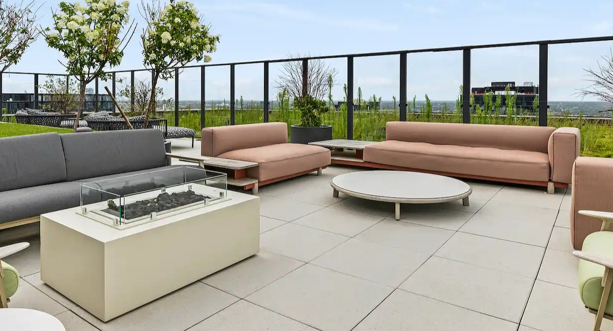 Luxurious outdoor lounge at The Elizabeth Chicago, featuring comfortable sofas, accent chairs, and a modern fire pit