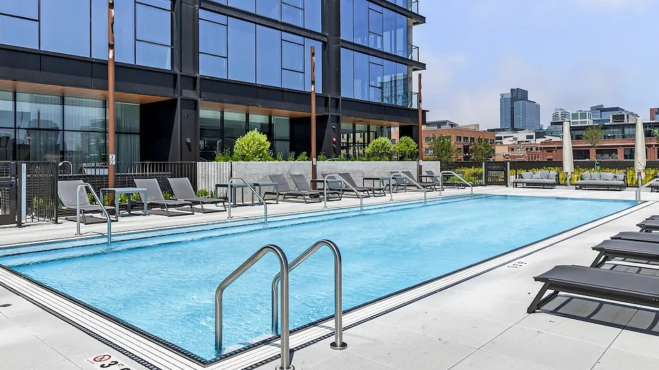 Inviting poolside lounge area at The Elizabeth Chicago, featuring comfortable chairs and direct access to the outdoor swimming pool
