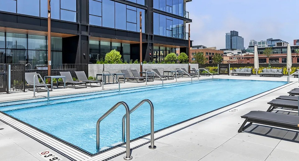 Inviting poolside lounge area at The Elizabeth Chicago, featuring comfortable chairs and direct access to the outdoor swimming pool