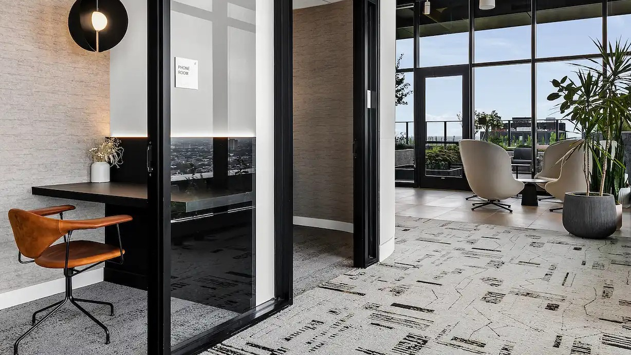 Modern private phone booth and workspace at The Elizabeth Chicago, offering a quiet area for calls and focused work