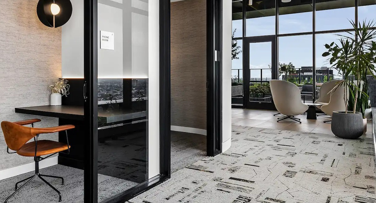 Modern private phone booth and workspace at The Elizabeth Chicago, offering a quiet area for calls and focused work