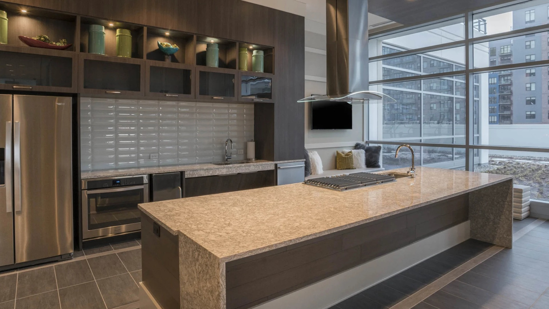 Elegant gourmet catering kitchen with a large island, stainless steel appliances, and ample space for entertaining at The Elle in Chicago