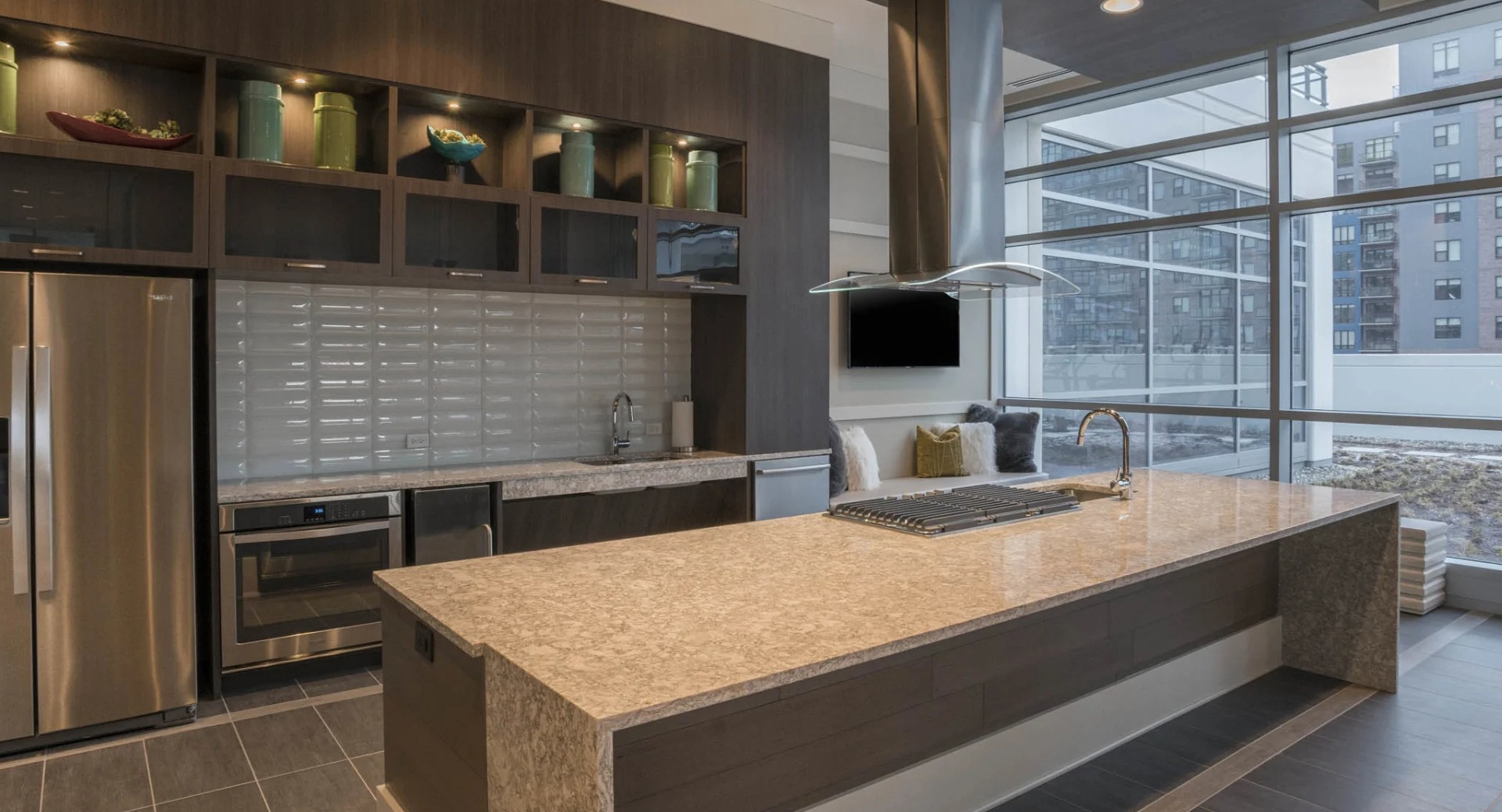 Elegant gourmet catering kitchen with a large island, stainless steel appliances, and ample space for entertaining at The Elle in Chicago
