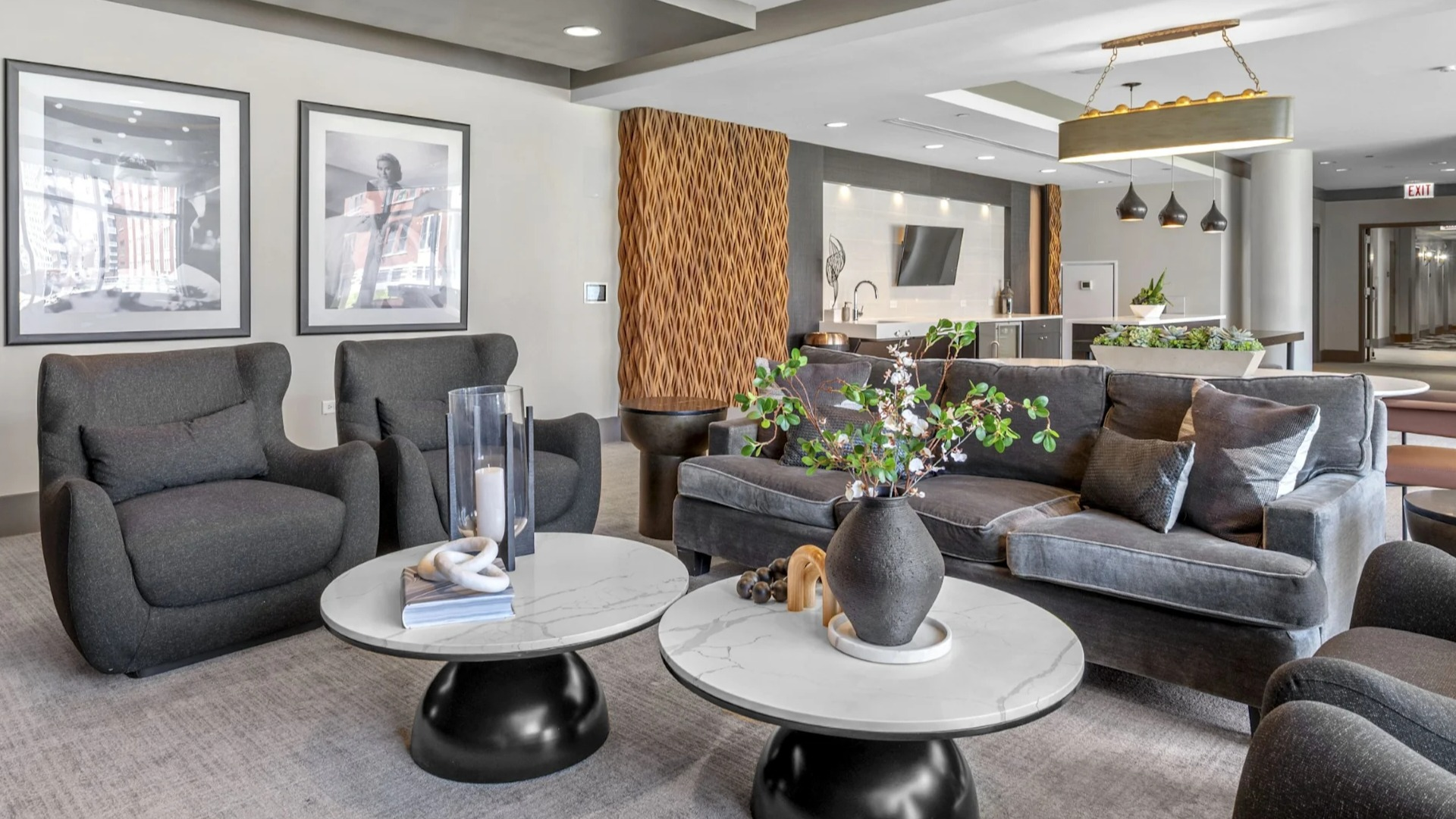 Stylish resident lounge featuring comfortable gray sofas, marble coffee tables, and contemporary artwork, perfect for socializing at The Elle in Chicago