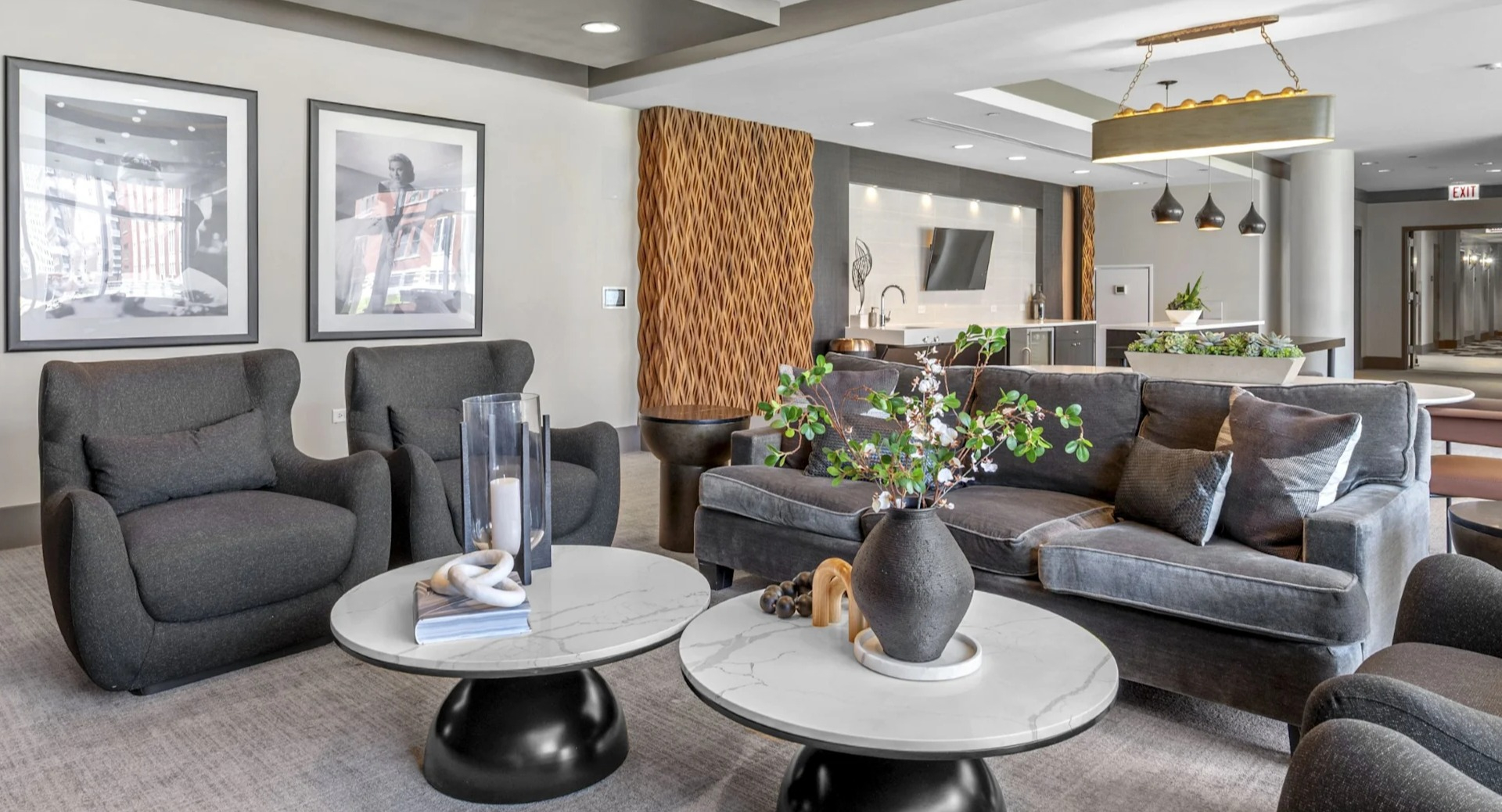 Stylish resident lounge featuring comfortable gray sofas, marble coffee tables, and contemporary artwork, perfect for socializing at The Elle in Chicago