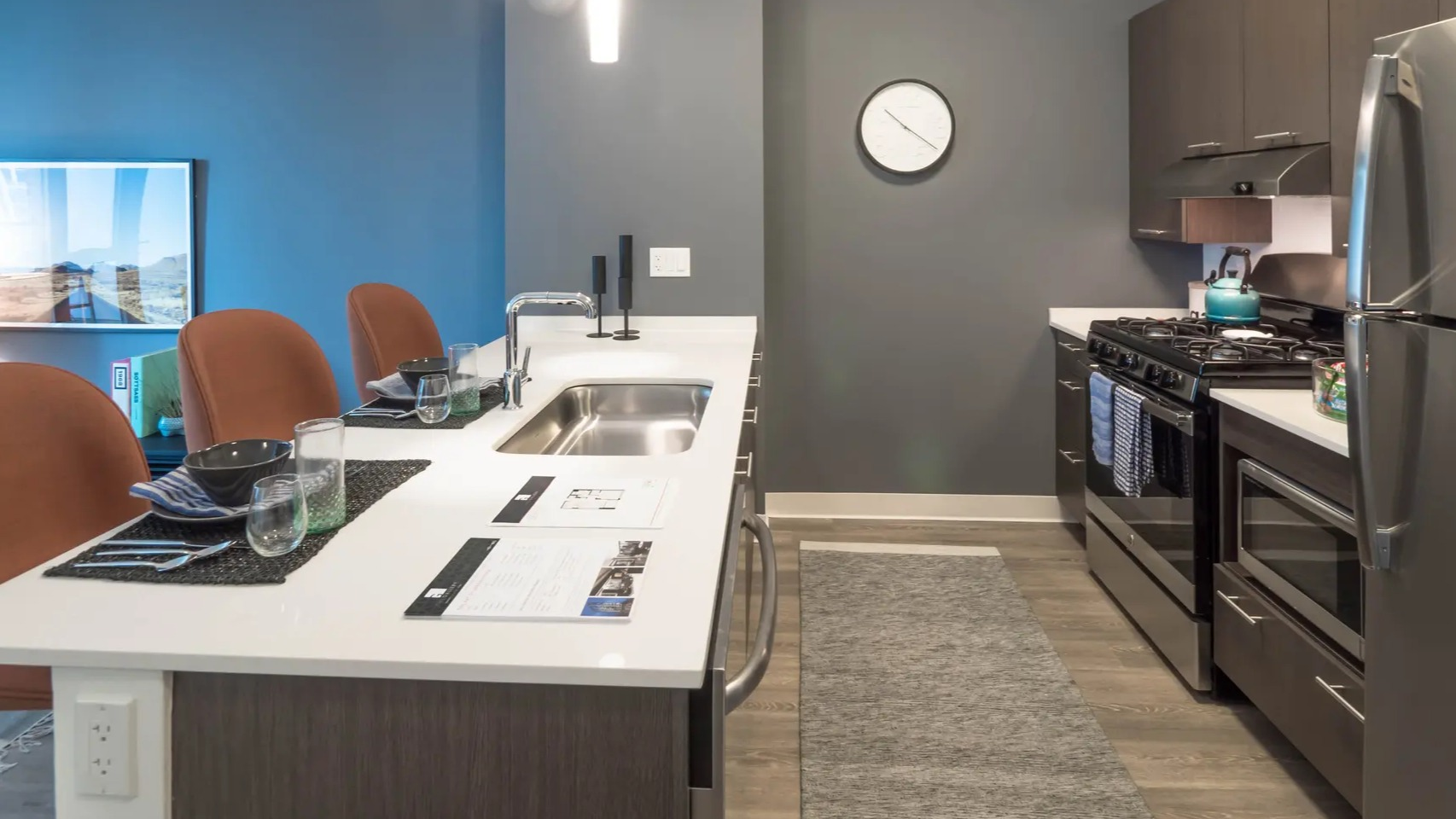 Contemporary apartment kitchen with a large island, stainless steel appliances, and a seamless connection to the living area at The Gallery on Wells in Chicago