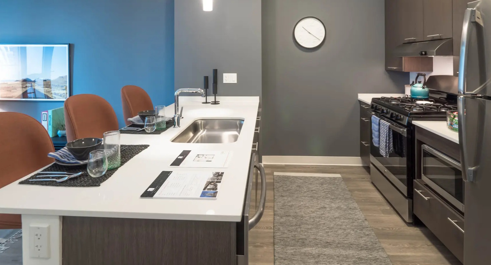 Contemporary apartment kitchen with a large island, stainless steel appliances, and a seamless connection to the living area at The Gallery on Wells in Chicago