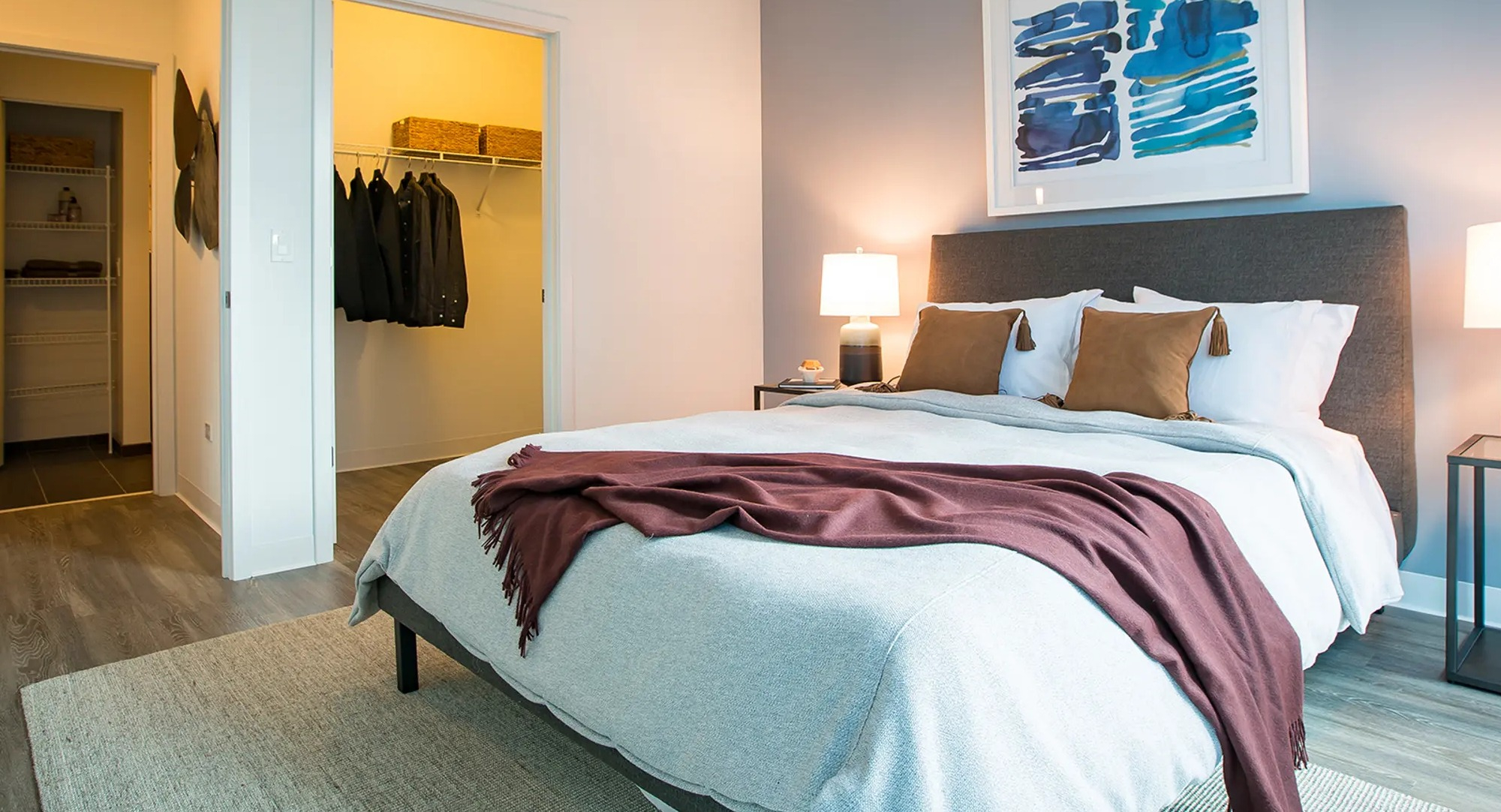 Inviting bedroom with a comfortable bed, vibrant accent wall, and a convenient walk-in closet at The Gallery on Wells in Chicago