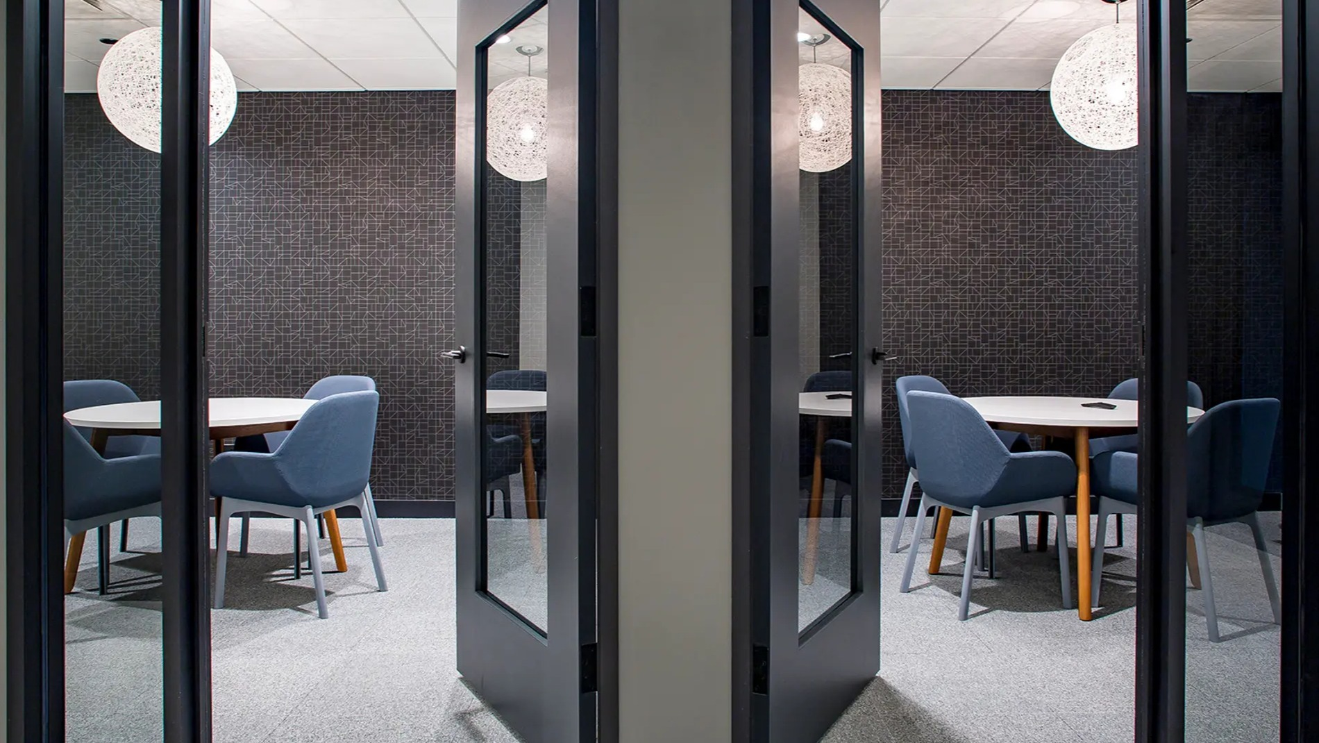 Modern private workspaces with individual tables and chairs, designed for focus and productivity at The Gallery on Wells in Chicago