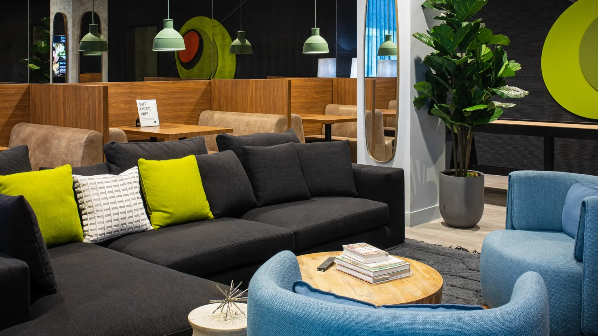 Vibrant resident cafe and lounge area with comfortable seating, private booths, and colorful decor elements at The Gallery on Wells in Chicago