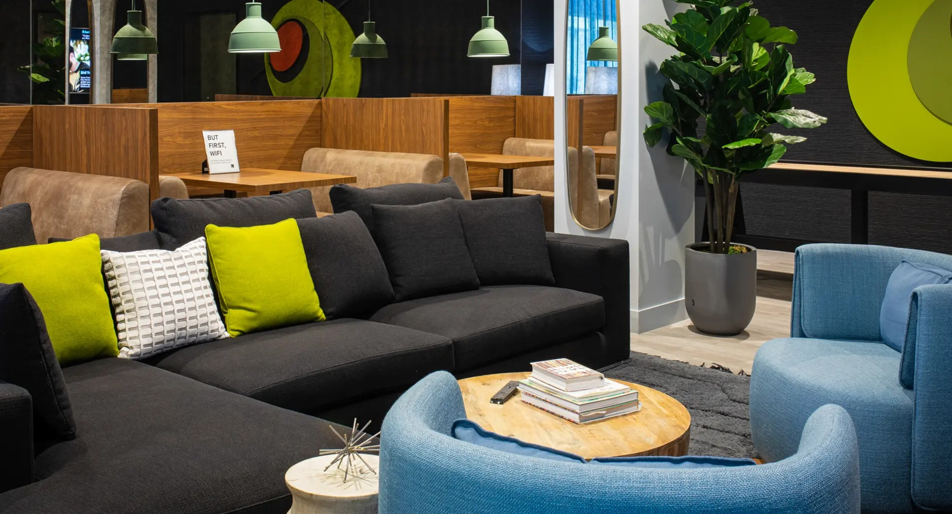 Vibrant resident cafe and lounge area with comfortable seating, private booths, and colorful decor elements at The Gallery on Wells in Chicago