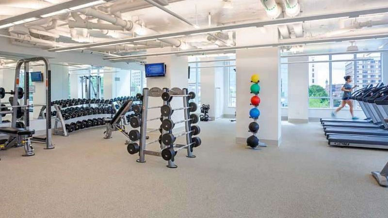 Expansive gym at The Hudson in Chicago, featuring a wide range of cardio machines, free weights, and modern strength equipment