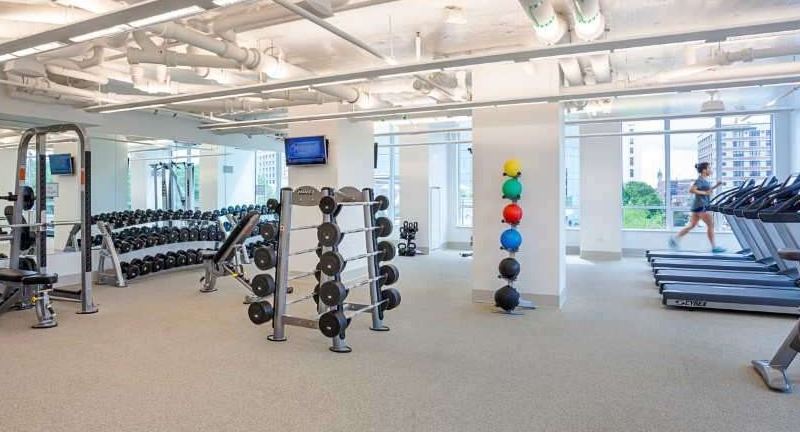 Expansive gym at The Hudson in Chicago, featuring a wide range of cardio machines, free weights, and modern strength equipment