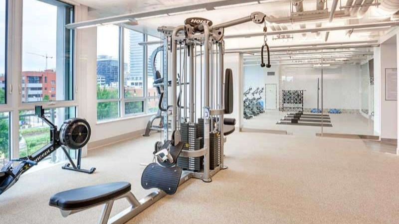 State-of-the-art fitness center at The Hudson in Chicago, featuring weight machines, free weights, and dedicated yoga space