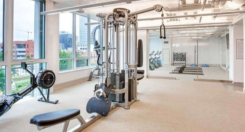 State-of-the-art fitness center at The Hudson in Chicago, featuring weight machines, free weights, and dedicated yoga space