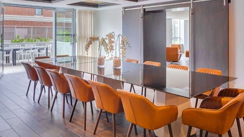 Elegant private dining room at The Hudson in Chicago, featuring a large table with seating and access to an outdoor patio