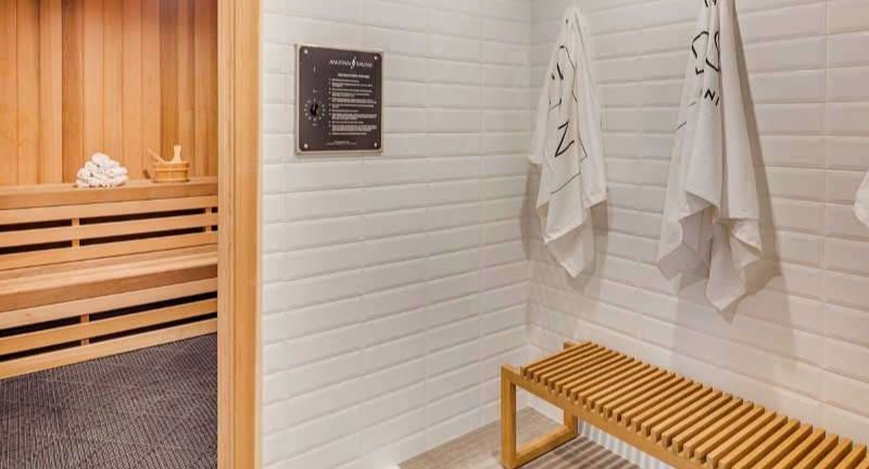 Relaxing sauna room at The Hudson in Chicago, featuring wooden benches and a serene atmosphere, perfect for unwinding