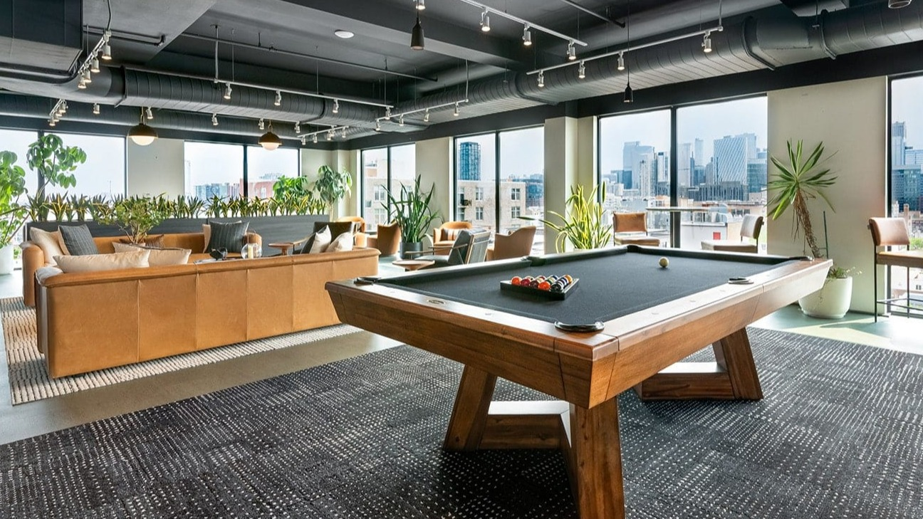 chicago-billiards-skyline Vibrant billiards room at The Jax in Chicago, featuring a modern pool table and expansive city skyline views
