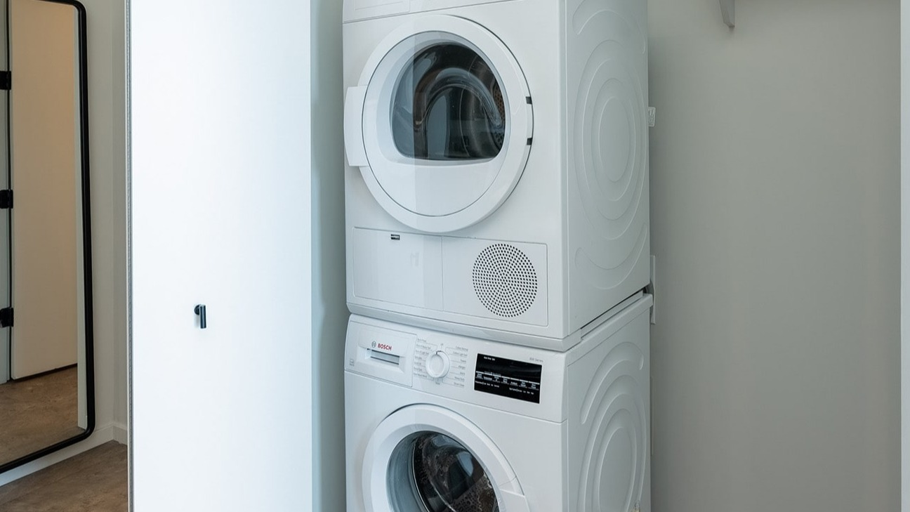 Convenient in-unit stacked washer and dryer at The Jax in Chicago, offering modern laundry solutions within your apartment