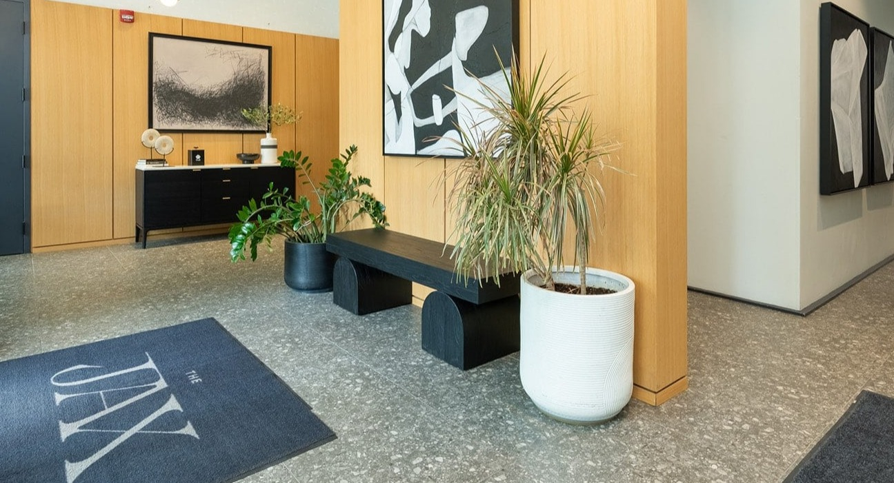 Stylish lobby entrance at The Jax in Chicago, featuring modern art, warm wood accents, and inviting decor
