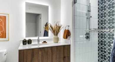 Contemporary bathroom at The Leo in Chicago, featuring a modern vanity, a walk-in shower with striking geometric tile, and stylish decor