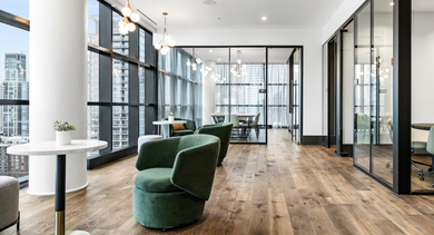 Modern co-working space at The Leo in Chicago, featuring individual workstations, comfortable seating, and city views