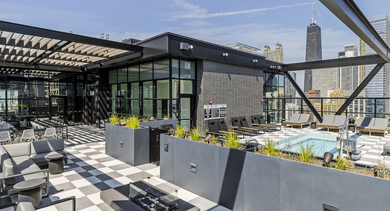 Luxurious rooftop pool deck at The Leo in Chicago, featuring a swimming pool, lounge chairs, and incredible city views