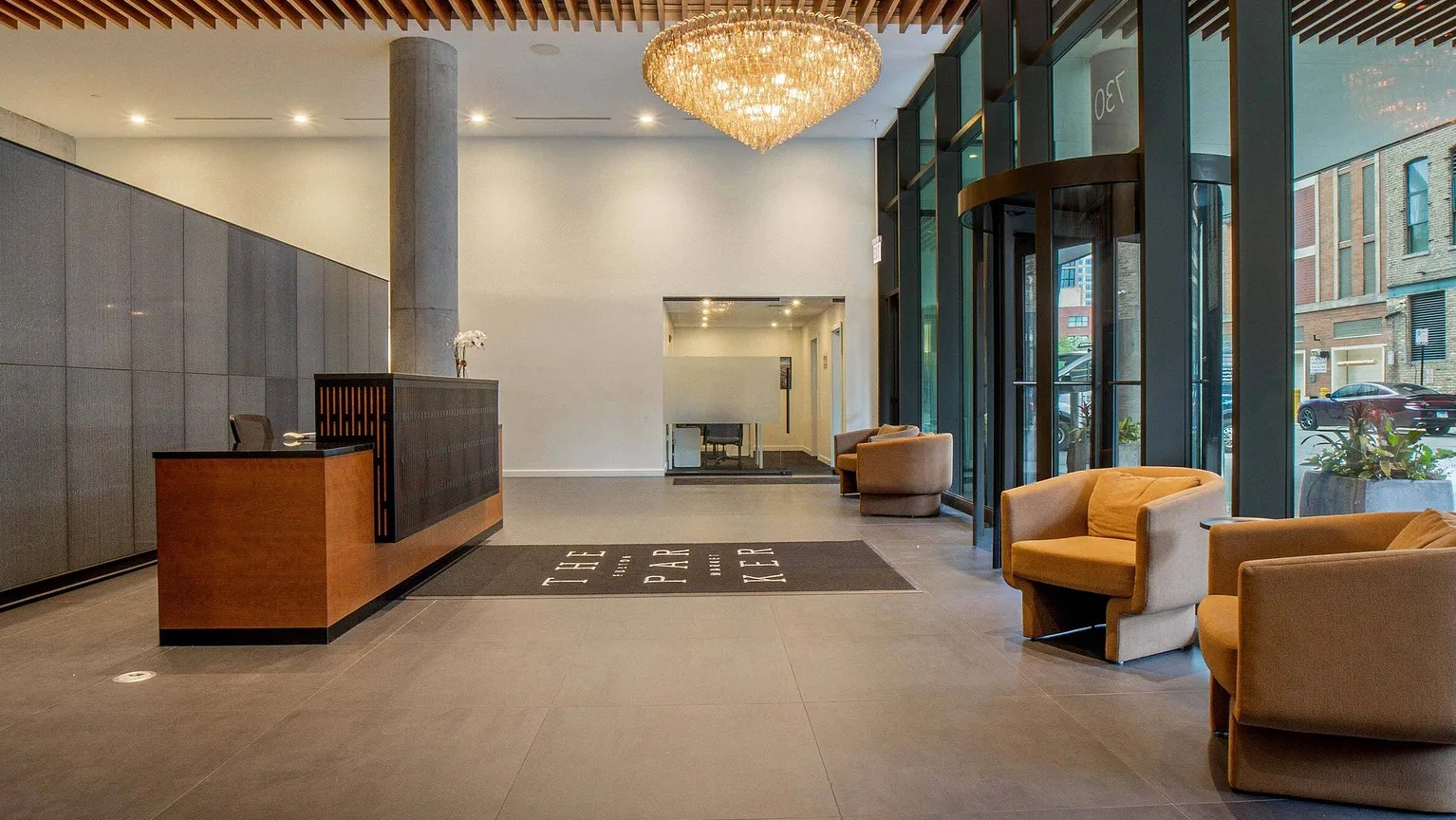 The grand and luxurious lobby entrance of The Parker Fulton Market, featuring a stylish reception desk, modern lighting, and comfortable seating in Chicago